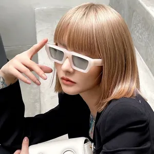 Retro rectangle sunglasses with white matte frames shown on fashion model