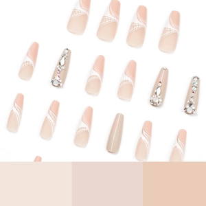 Long ballet press-on nails set with nude base colors, white swirls, and rhinestone accents