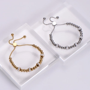 Detail view of gold and silver beaded bracelets with rhinestone spacers and pull closure