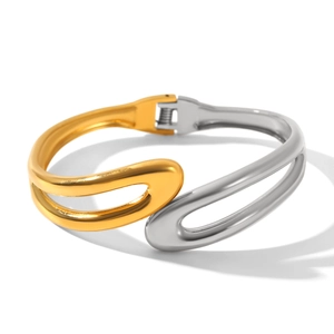 Detail of two-tone stainless steel bangle with streamlined hollow design and spring hinge