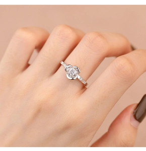 Close-up of S925 sterling silver rose ring with pavé zircons on woman's finger