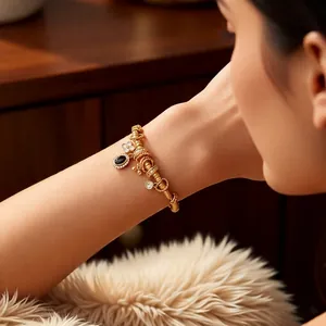 Vintage Chinese style gold carp bracelet with black oval gemstone and clover charms
