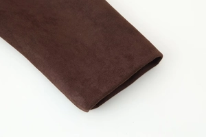 Detailed close-up showing the velvet fabric texture and sleeve cuff stitching of the blazer