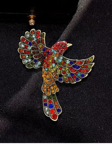Macro shot of colorful rhinestones on a vintage bird brooch with polished metal base