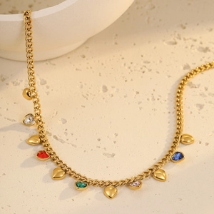 Golden Cuban link necklace featuring colorful heart-shaped zirconia and polished heart charms