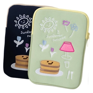 Blue and mint green laptop sleeves with sun and pancake embroidery on white background