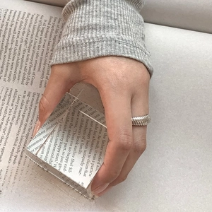 Detail of minimalist 925 sterling silver ring with diagonal twill pattern on hand