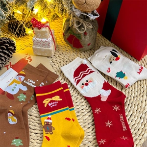 Christmas cotton socks set featuring Santa and snowman patterns in a festive setting