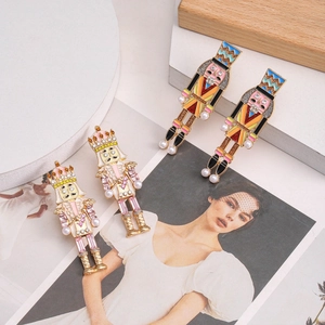 Detailed view of nutcracker earrings featuring pearls, rhinestones and colorful enamel inlay
