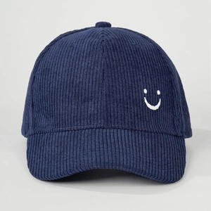 Detail of navy corduroy baseball cap with embroidered smiley face and ribbed texture