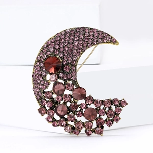 Elegant crescent moon brooch with purple rhinestones on a vintage gold metal base