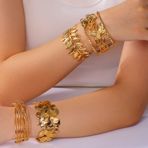 Bohemian gold open bangles set featuring hollow leaf, butterfly, and flower designs for women
