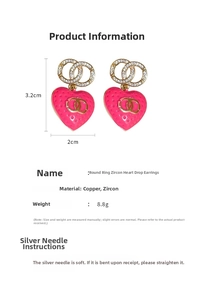 Detail showing fuchsia heart earrings with white cubic zirconia and gold interlocking CC logo