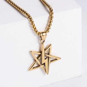 Gold stainless steel pentagram and lightning bolt pendant necklace on geometric blocks