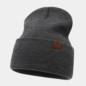 Detail of dark gray knit hat with thick ribbed texture and leather snowflake patch