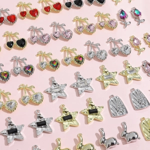 Flat lay variety of Y2K DIY charms including cherry, star, and rabbit shapes in multi-colors