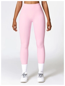 Close-up of high-waist yoga leggings in soft pink with wide waistband for tummy control