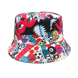 Detail of colorful graffiti prints featuring lips and dice on a reversible bucket hat