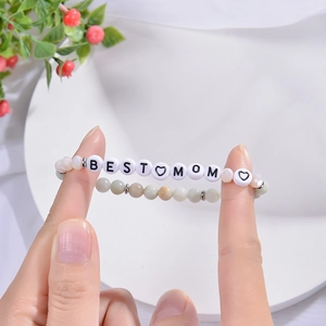 Detail of Amazonite beaded bracelets with Daughter and Best Mom charms on white background