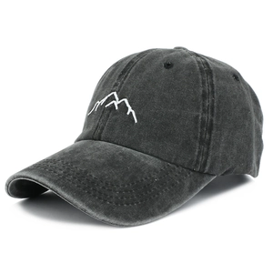 Close-up of vintage washed black baseball cap featuring detailed mountain embroidery