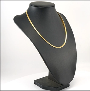 Detailed view of an 18K gold plated snake chain necklace displayed on a black neck model
