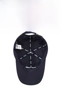 Detailed interior of a navy baseball cap featuring breathable vents and a metal buckle adjustment