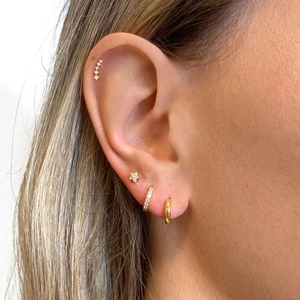 Detailed view of layered gold S925 silver star studs and cubic zirconia hoop earrings