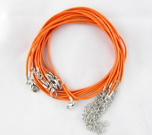 Close-up of orange waxed cord necklace with silver lobster clasp and extender chain