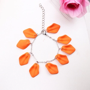 Detail of bohemian silver chain bracelet featuring eight matte orange petal pendants