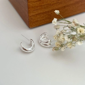 Minimalist 925 sterling silver C-shaped hoop earrings with a polished metallic finish