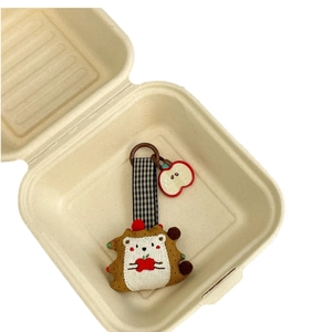 Cute fabric hedgehog keychain with red apple and black white plaid strap in a gift box