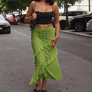Women's summer fashion set with black lace crop top and green lace maxi skirt in street style