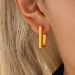 Rectangular 18K gold plated stainless steel geometric hoop earrings worn by a model