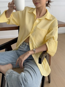 Detailed close-up of yellow vertical stripes on professional casual women shirt