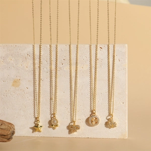 French vintage gold necklaces with star, rose, and angel coin pendants in a vertical layout