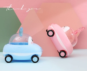 Detail of pink and blue cartoon toy cars with glitter lids for baby birthday gift boxes