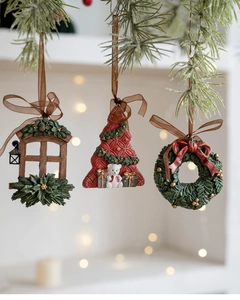 Close-up of resin Christmas ornaments featuring a 3D tree, wreath and window designs