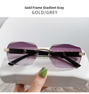 Detail of rimless gradient grey sunglasses with gold arrow temples and a white case