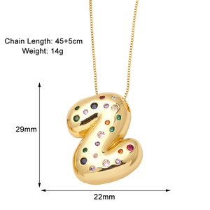 Detail view of gold letter Z pendant with colorful zircon stones and dimension labels