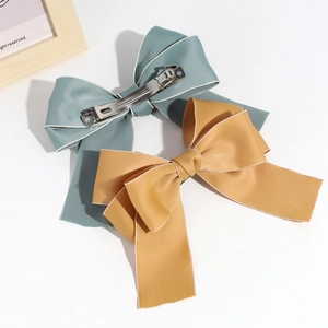 Teal and yellow ribbon bow hair clips with silver metal spring clips for women