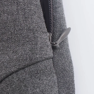 Detail of hidden back zipper and grey woven fabric texture on a sexy lace mini dress