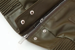 Detail of olive green leather jacket featuring metal zipper, silver snaps and quilted texture