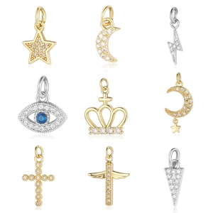 Assorted gold and silver pendants featuring stars, moon, and cross shapes with zircon inlays