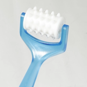 Close-up of manual roller massager with blue handle and white massage texture nodes