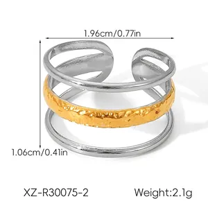 Detailed view of triple-layered gold and silver stainless steel ring with dimensions