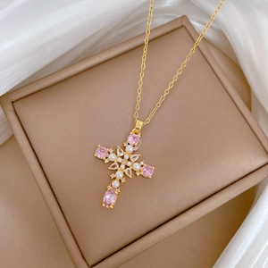 Luxurious gold stainless steel cross necklace with pink stones and pearls on silk