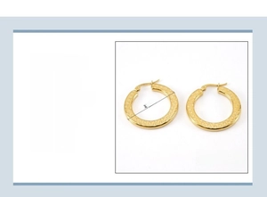 Detail view of 32mm gold stainless steel hoop earrings with 18K vacuum plating finish