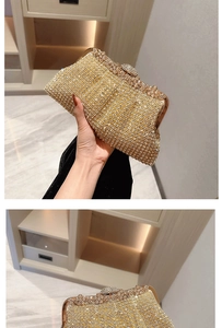 Macro shot of luxury gold rhinestone clutch bag showing sparkling crystal wave patterns