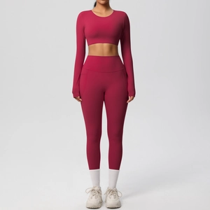 Detail view of dark red high-waisted yoga pants with functional side pocket for phone