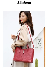 Detail of red crocodile pattern handbag with metal twist lock and stylish top handle